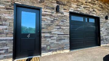 A building with two garage doors and a stone facade.