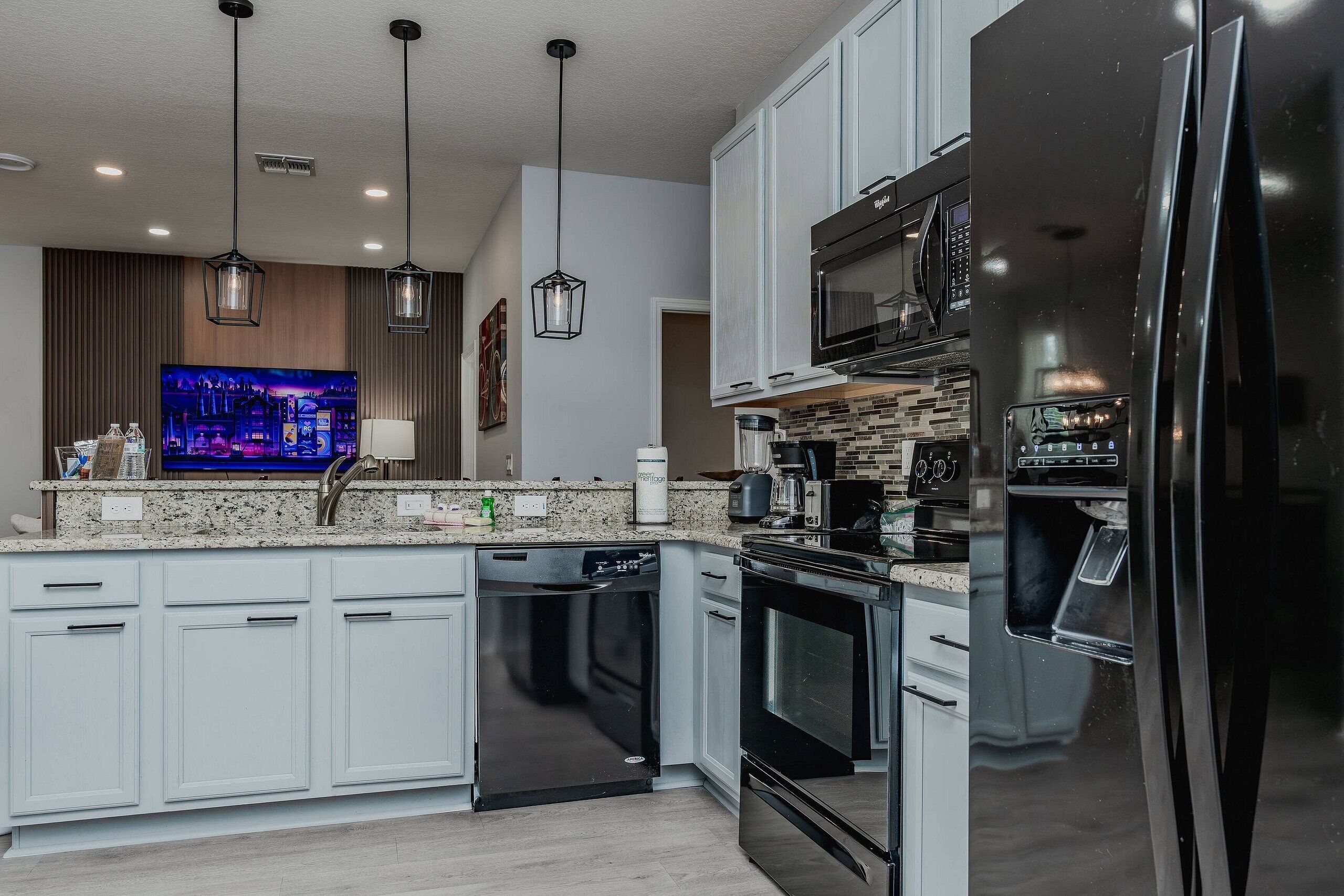 A modern kitchen with a built-in dishwasher, a microwave, and a refrigerator.