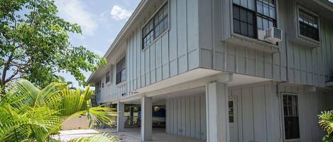 A two-story building with a covered porch and a garage.