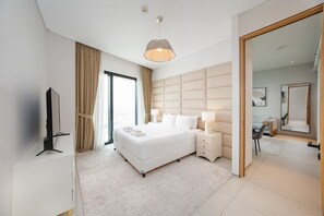 A modern hotel room with a large bed, bedside tables, a flat-screen TV, and a large mirror. - Chic Address JBR Haven w/ Marina View (Dubai)