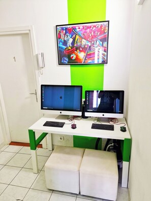 A room with a desk featuring two monitors, a keyboard, and a mouse. A colorful painting is on the wall above the desk. - Croparadise Central (Split)
