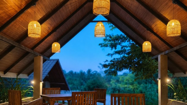 An outdoor covered dining area with wooden furniture and hanging lights. - J Villa Sigiriya - Private Pool Chalets (sigiriya)