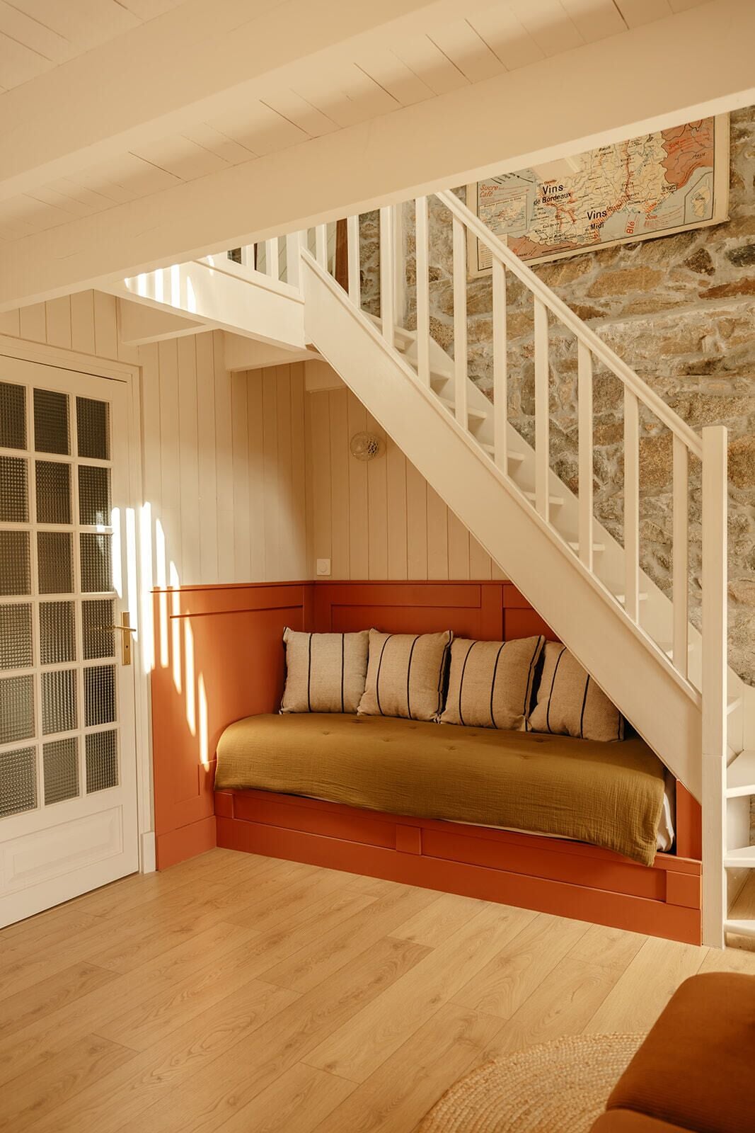 Un escalier menant à un niveau inférieur, avec un banc au bas.