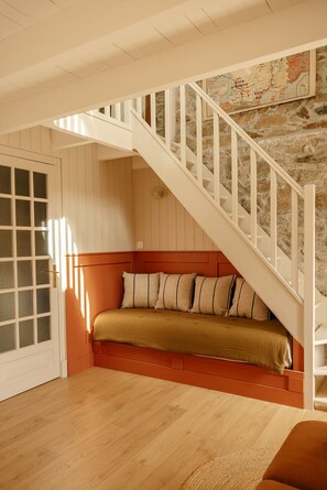 A staircase leading to a lower level with a bench at the bottom.