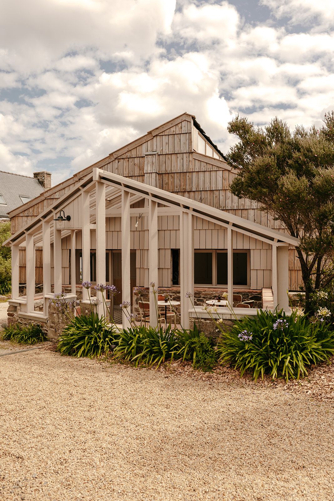 A rustic wooden building with a covered patio area.