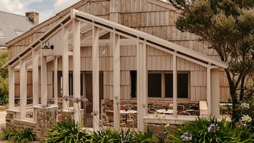 A rustic wooden building with a covered patio area.