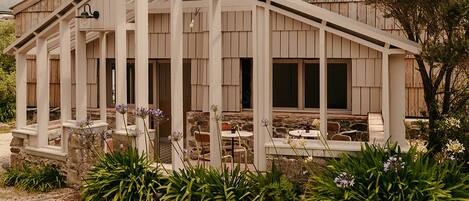 A rustic wooden building with a covered patio area.