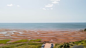 A coastal landscape with a parking area and a view of the sea. - Lupin Lane Beach Retreat (Stratford)