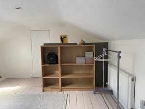 A room with a wooden shelving unit, a radiator, and a hanger bar. - Cosy & private cottage nestled in the Wicklow Mountains. Pet friendly! (Tinahely)