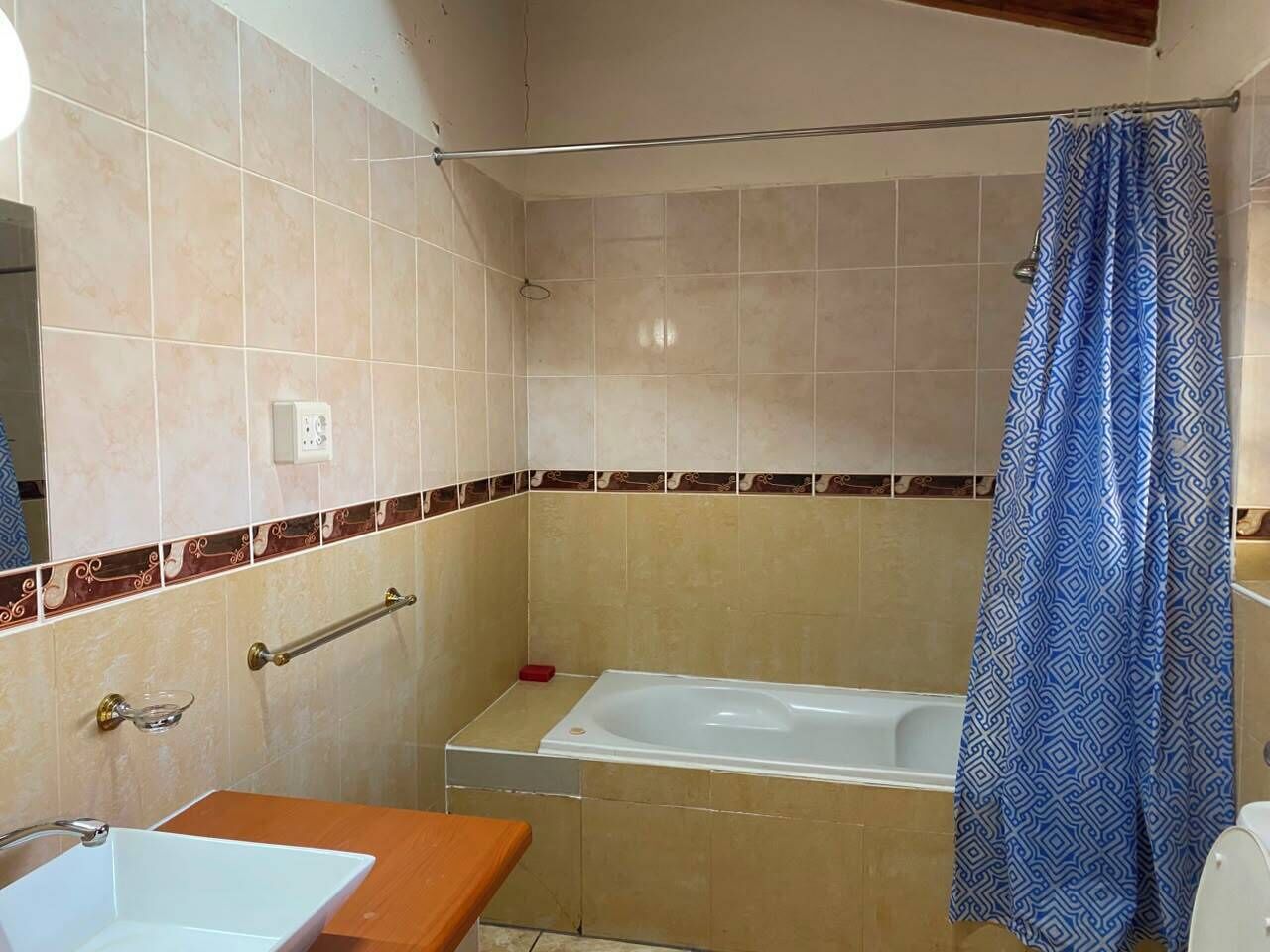 A bathroom with a bathtub, a toilet, and a sink.
