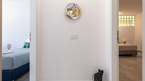 A bedroom with a bed, a wall-mounted light switch, and a cat-shaped decoration. - Bright home 200m from the Beach (Porto Rafti)