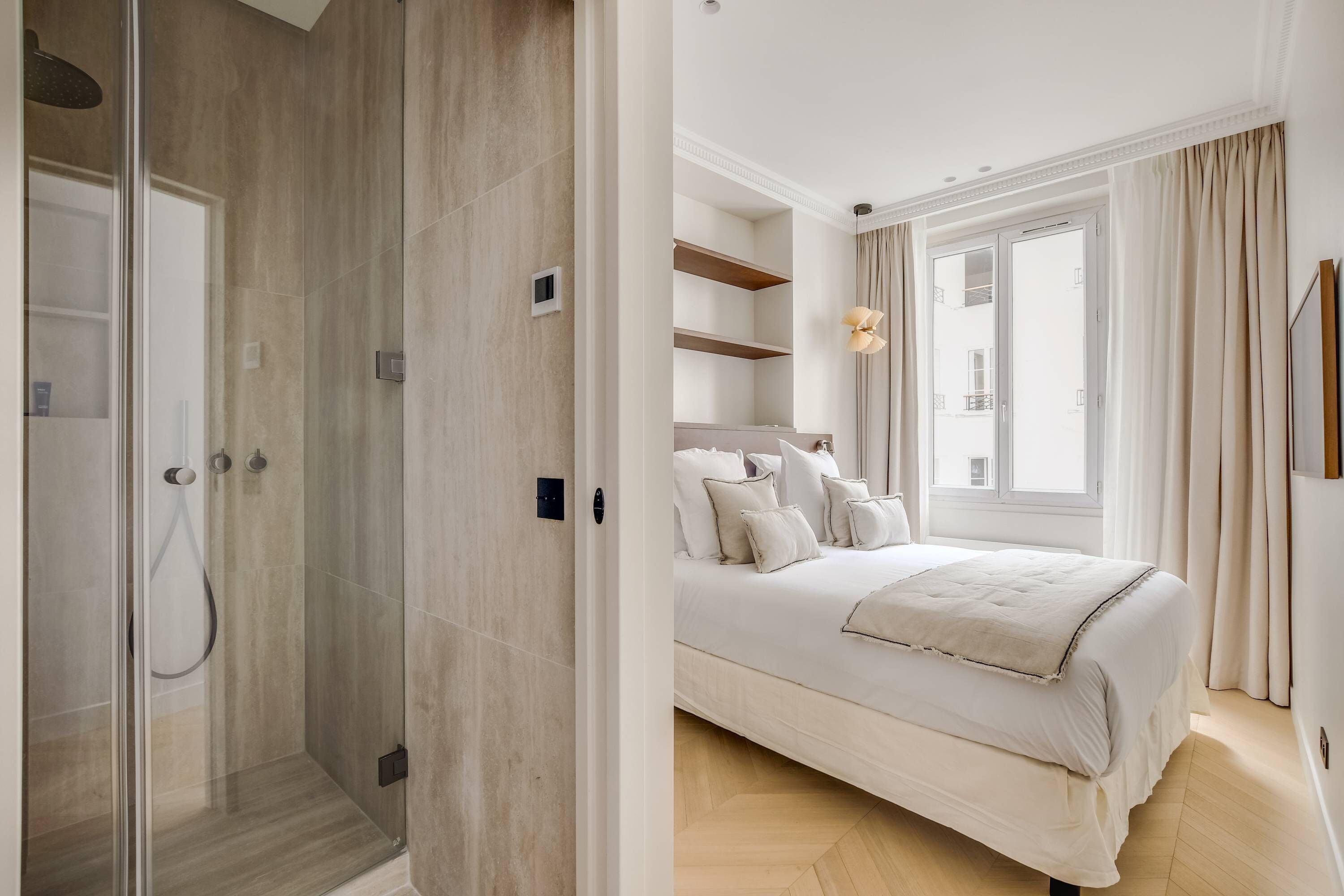 A modern bathroom with a glass shower enclosure and a separate shower area.