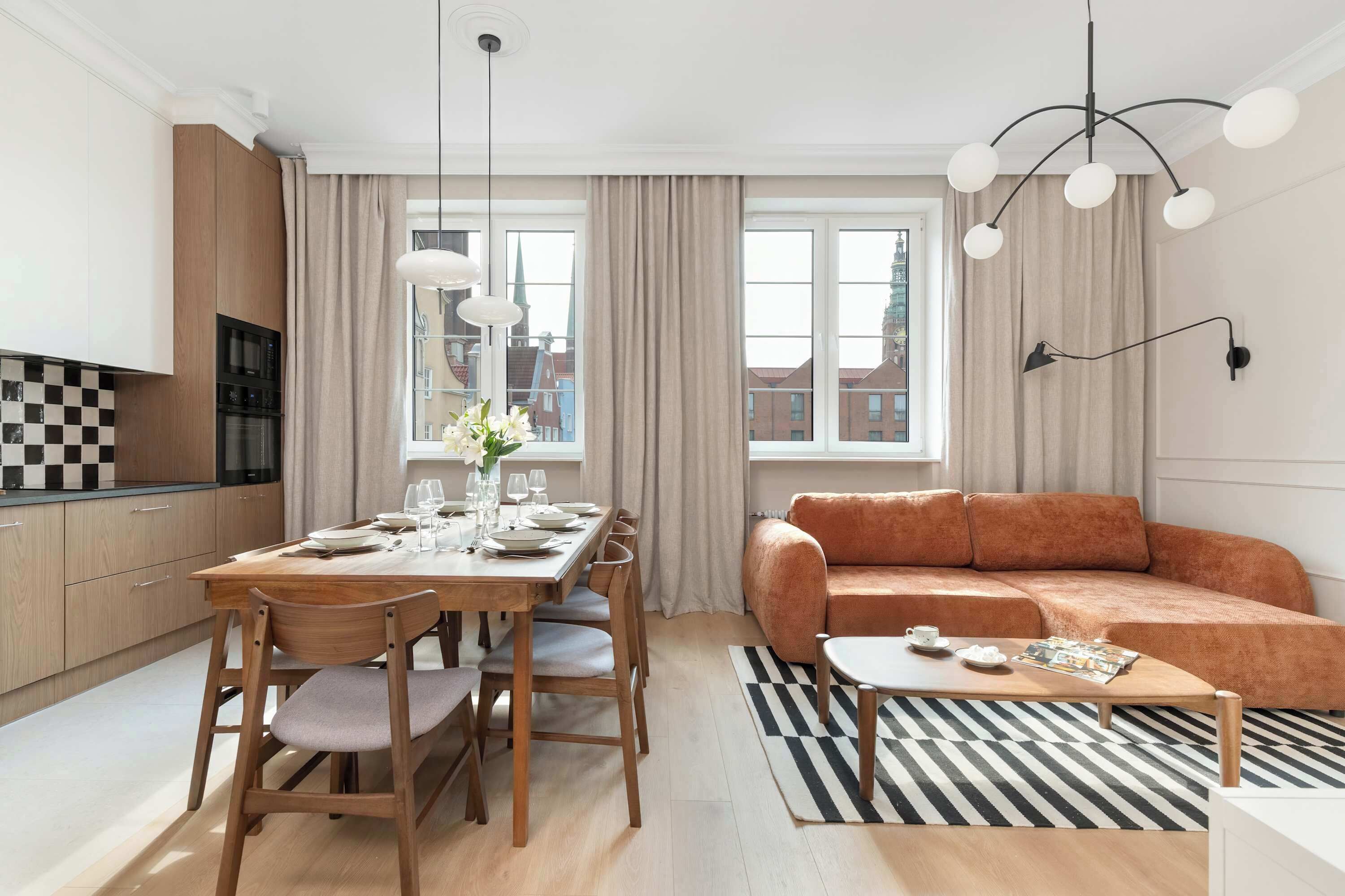 A modern living room with a dining area, a sofa, and a coffee table.