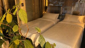 A room with two beds, a potted plant, and a window overlooking a building. - Flam Hotel Luxury Penthouse Osaka | Sauna & Rooftop Terrace Near USJ (大阪市)
