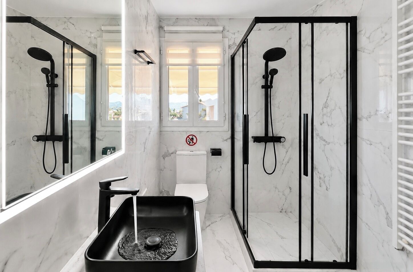 A modern bathroom with a shower enclosure, a toilet, and a sink with a tray.