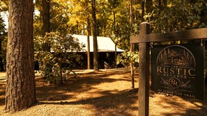 A rustic reserve sign with a house illustration, located at Broken Bow, Oklahoma, 101 Scrub Trail. - Secluded Cabin Perfect for Couples & Families with Hot Tub & Stone Fireplace in Broken Bow, Oklahoma (Broken Bow)
