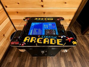 A retro arcade machine with a digital display and joystick controls. - Secluded Cabin Perfect for Couples & Families with Hot Tub & Stone Fireplace in Broken Bow, Oklahoma (Broken Bow)