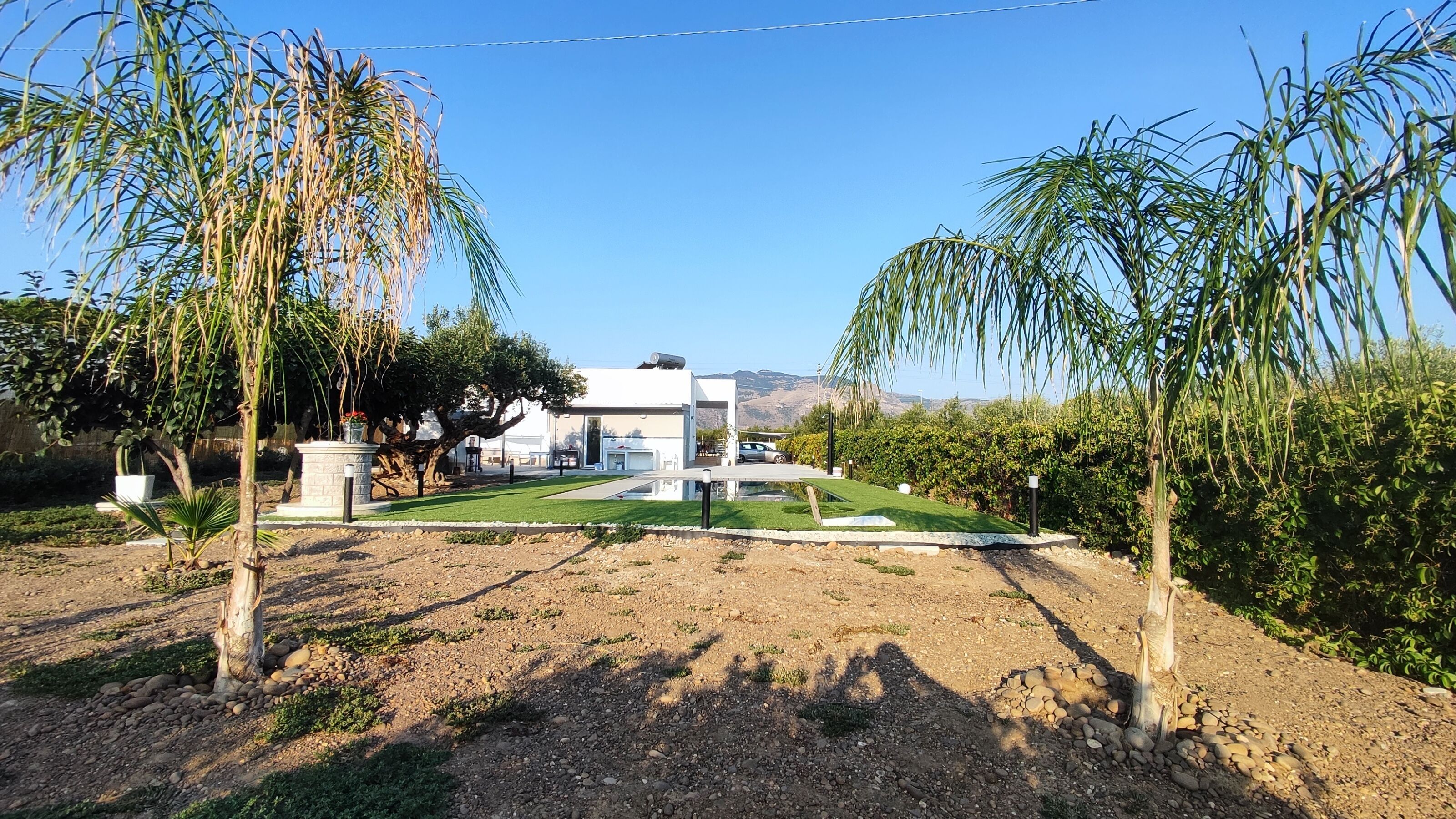 A modern house with a well-maintained lawn, a driveway, and a garage.