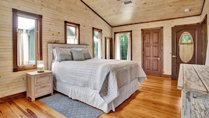 A wooden-paneled bedroom with a bed, nightstand, and dresser. - "Catican Bayou" Fish River Waterfront Home 3 bedrooms; 5 bathrooms  Kayaks (Summerdale)