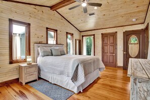 A wooden-paneled bedroom with a bed, nightstand, and dresser. - "Catican Bayou" Fish River Waterfront Home 3 bedrooms; 5 bathrooms  Kayaks (Summerdale)