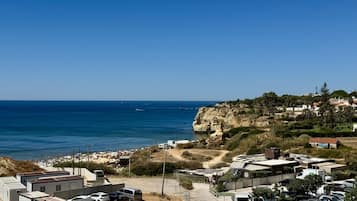Zona costera con estacionamiento, playa y edificios.