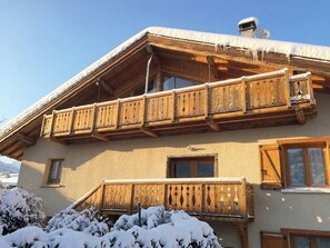 A two-story chalet with wooden balconies and a snow-covered roof. - Le Refuge de l'Atelier, nestled in the heart of the village of Longefoy near La Plagne (Aime-la-Plagne)