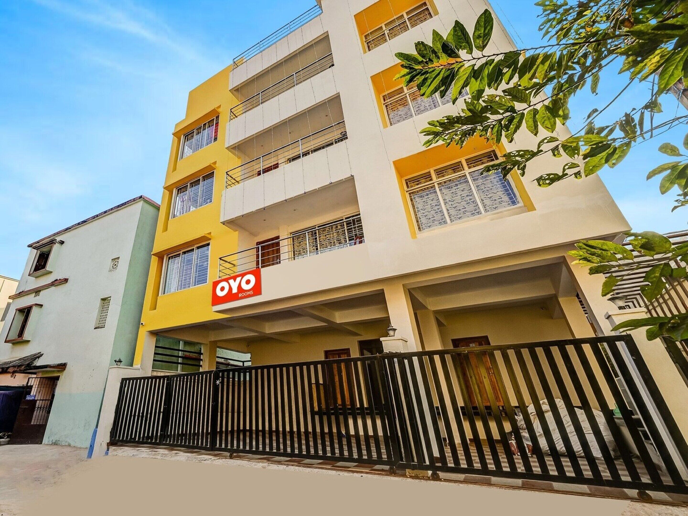 A multi-story building with a sign for 'OYO ROOMS' indicating a hotel or lodging establishment.