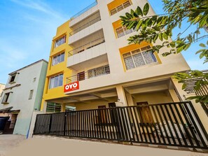 A multi-story building with a sign for 'OYO ROOMS' indicating a hotel or lodging establishment. - Classic Dream Marion (Bhubaneshwar)