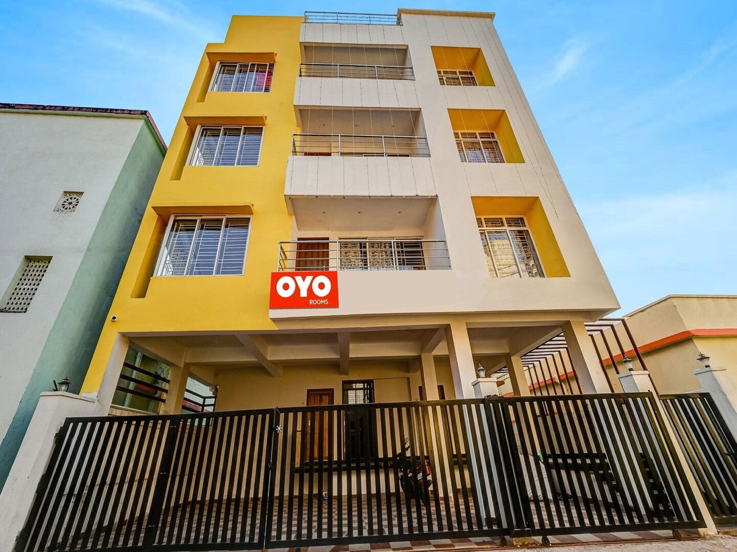 A multi-story building with a prominent 'OYO ROOMS' sign on the facade.