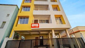 A multi-story building with a prominent 'OYO ROOMS' sign on the facade.