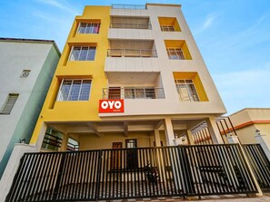 A multi-story building with a prominent 'OYO ROOMS' sign on the facade. - Classic Dream Marion (Bhubaneshwar)