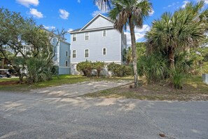 A two-story building with a front lawn and palm trees. - Walk to the Beach, Elevator, Golf Cart Included - 619 Dolphin Rd (Fripp Island)
