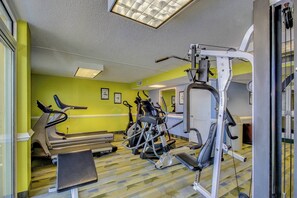 A gym with treadmills, elliptical machines, and weight equipment. - Blue Haven by StayMareni - Oceanfront Suite (Myrtle Beach)