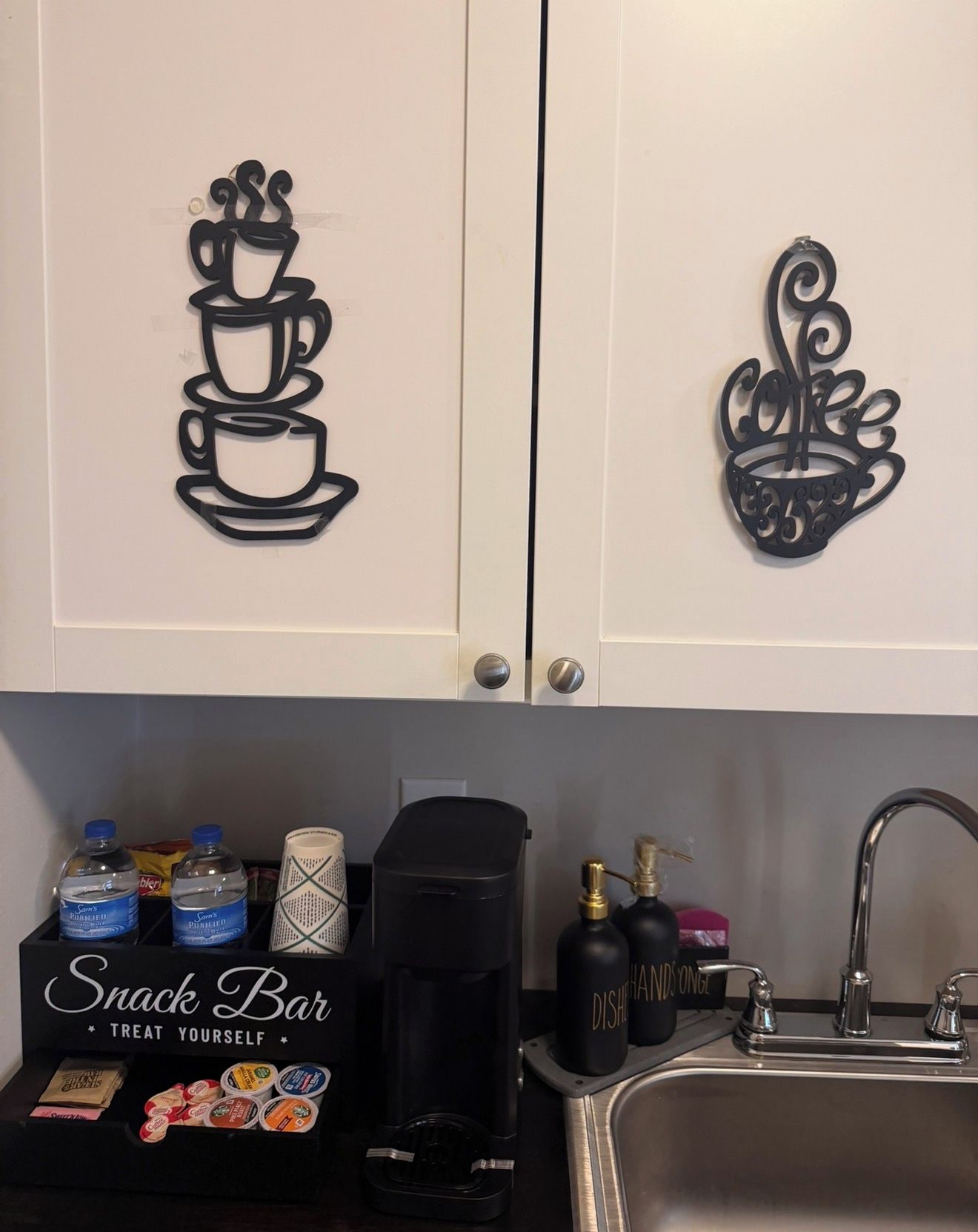 A kitchen with a snack bar area, a coffee maker, and a sink.