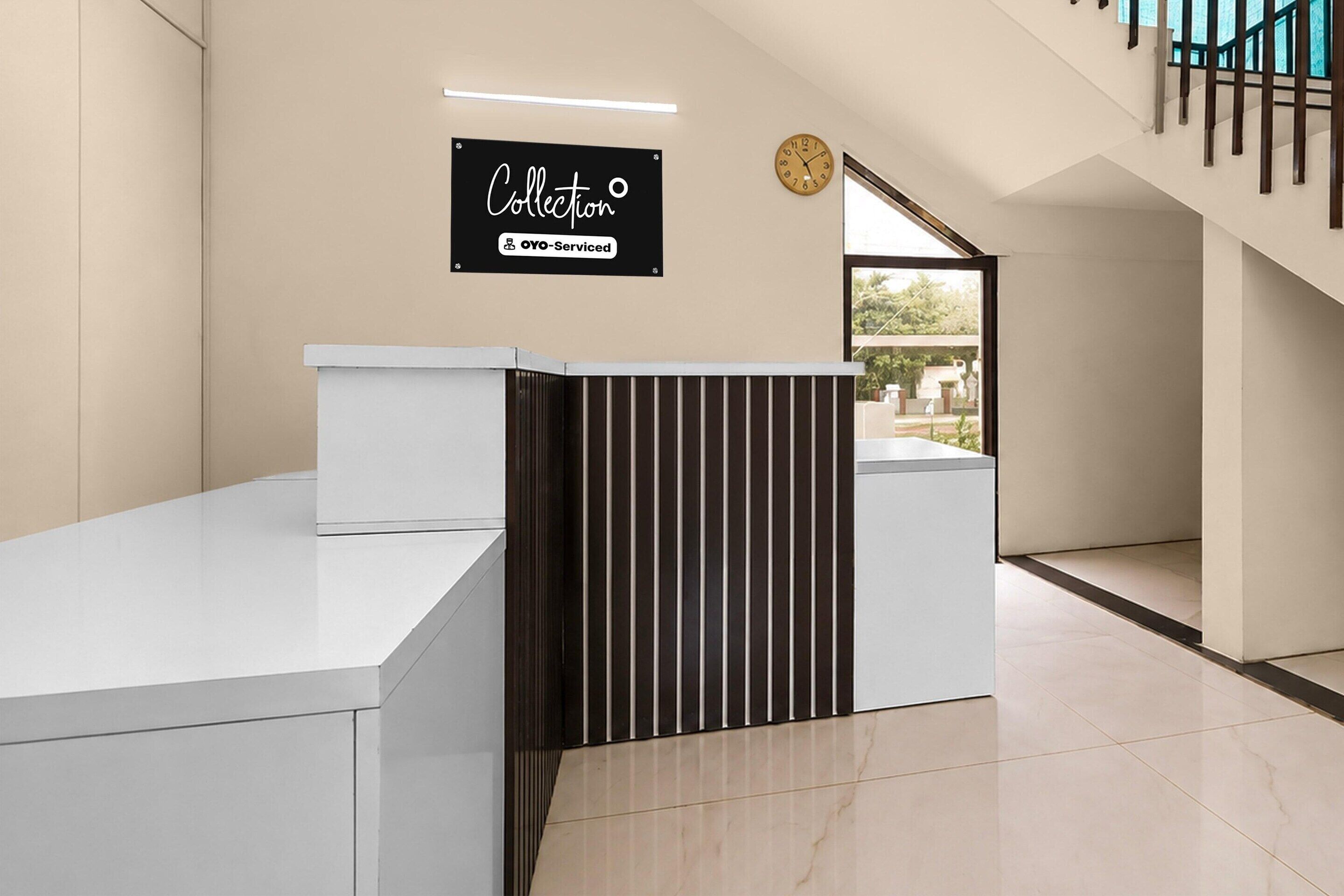 A reception desk with a sign indicating it is serviced by OYO.
