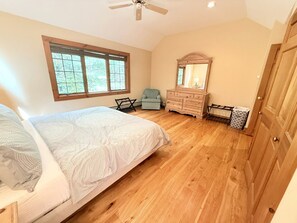 A bedroom with a bed, dresser, mirror, and a window. - Mountain Retreat with Stone Fireplace & Game Room Near Stratton, Magic Mountain & Bromley Mountain, Peru, Vermont (Peru)