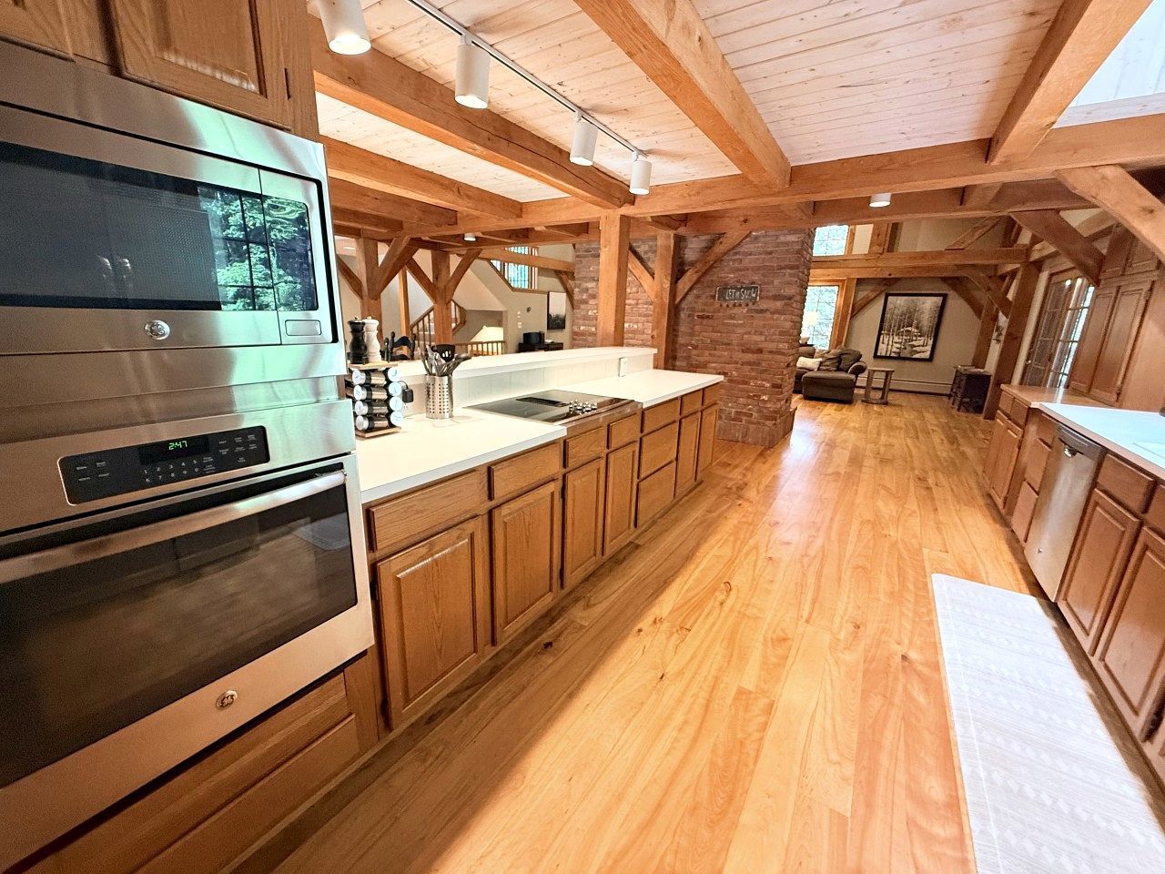A spacious kitchen with wooden cabinets, a large island, and a built-in oven.