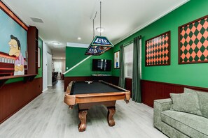 A billiards room with a pool table, a green wall, and a framed chessboard. - 5BR Veranda Palms Home Near Disney for 14 (Kissimmee)