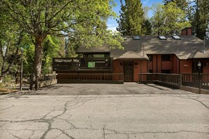 A building with a parking lot, a gated entrance, and a sign indicating a medical facility. - Slope & Cedar House | Hot tub, Steps 2 Snow Summit (Big Bear Lake)
