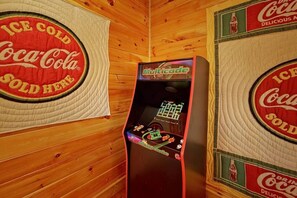 A room with wooden walls and a retro arcade machine. - Peaceful 3BR*MTN Views*Hot Tub*Pool Table*Fire Pit (Sevierville)