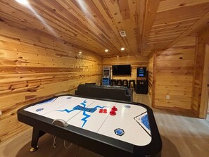 A room with a pool table, wooden walls, and a television. - 5BR Pool Cabin w/MTN Views! Hot Tub*Games*Zipline! (Sevierville)