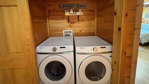 A laundry room with two Samsung washing machines and a sign above them. - 5BR Pool Cabin w/MTN Views! Hot Tub*Games*Zipline! (Sevierville)