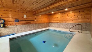 An indoor swimming pool with wooden walls and a tiled floor. - 5BR Pool Cabin w/MTN Views! Hot Tub*Games*Zipline! (Sevierville)