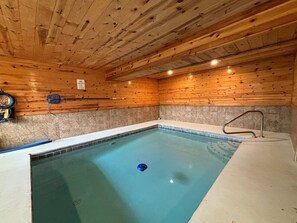 An indoor swimming pool with wooden walls and a tiled floor. - 5BR Pool Cabin w/MTN Views! Hot Tub*Games*Zipline! (Sevierville)