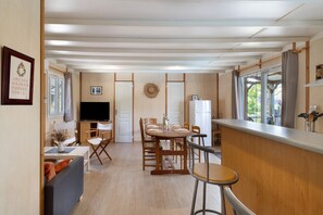 A compact living space with a dining area, kitchen, and seating area.