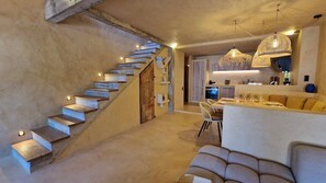 A modern interior with a staircase leading to a dining area, a kitchen, and a living space. - Casa Solea - Gulf of Saint-Tropez (Le Plan-de-la-Tour)