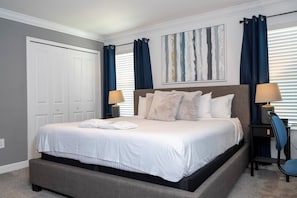 A bedroom with a large bed, two bedside lamps, a headboard, and a window with curtains. - ☆☆☆☆☆Price Drop! OCT-NOV - 4BR ChampionsGate - Pool - Themed Rooms! 
☆☆☆☆☆ (Davenport)