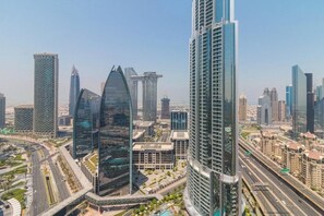 A cityscape with modern high-rise buildings, roads, and a clear sky. - Spacious Studio Fashion Ave Dubai Mall Burj view (Dubai)