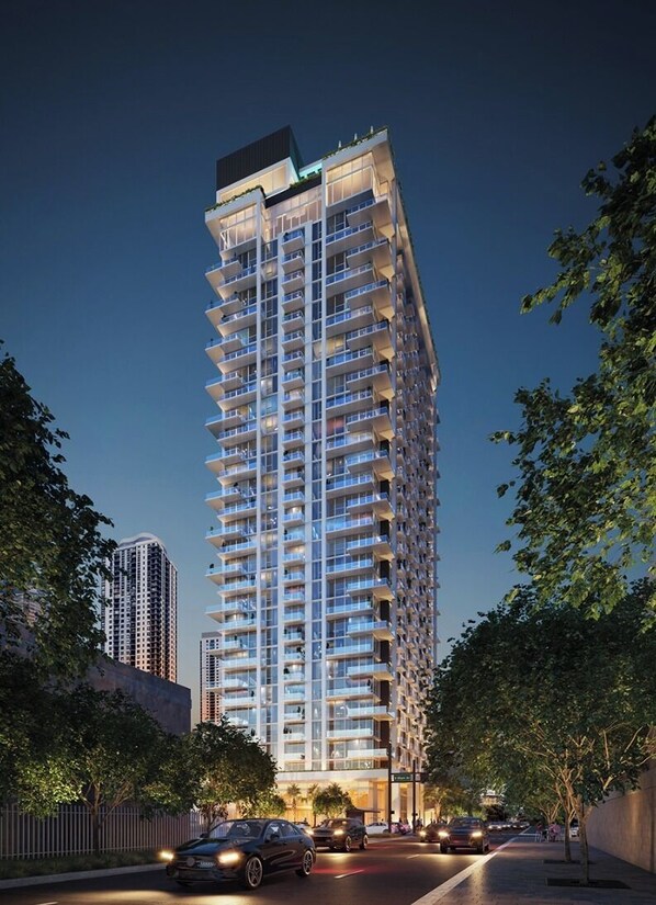 A high-rise building with multiple balconies, surrounded by trees and a street with cars. - Miami Urban Retreat (Miami)