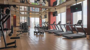 A gym with treadmills, weight machines, and exercise bikes.